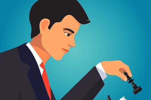 Confident businessman playing a chess